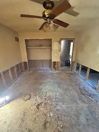 Drywall cut above the water line in a Plant City bedroom during a dry-out