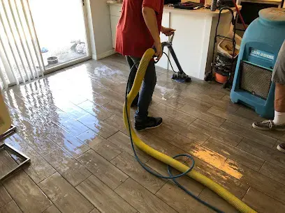 Extraction wand and LGR dehumidifier drying a wet tile floor in a Plant City, FL home