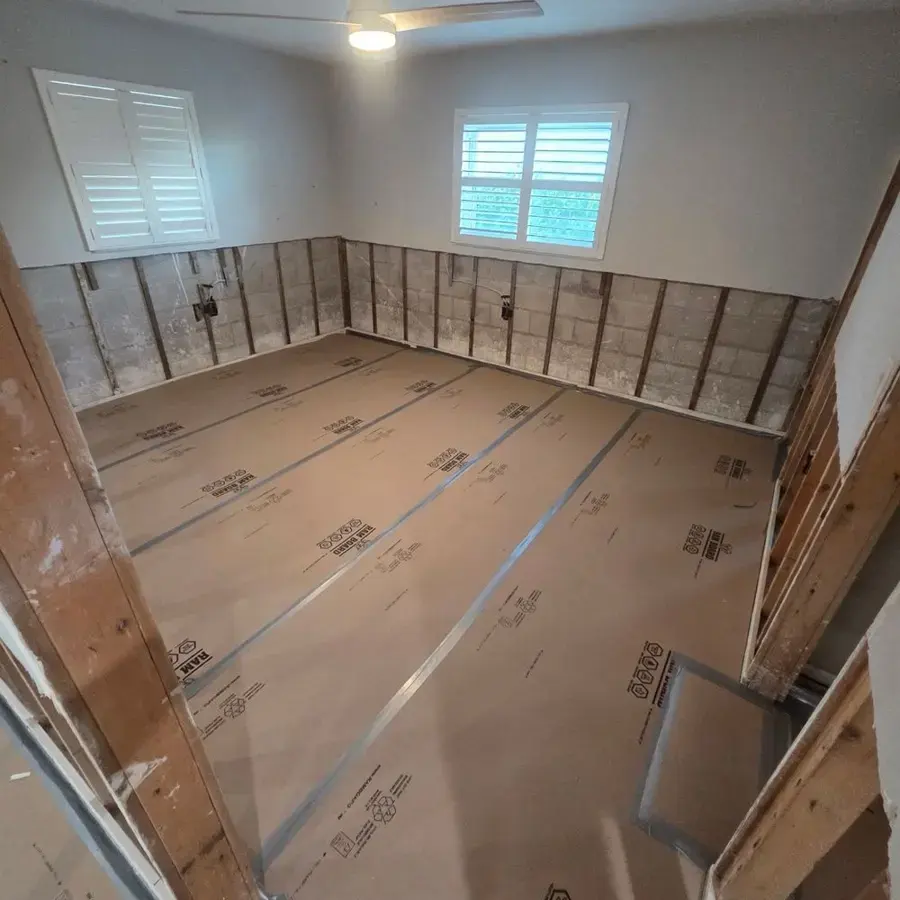Flood-cut bedroom with protected floor during structural drying in Plant City, FL