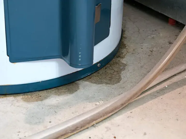 Water pooling around the base of a leaking tank water heater